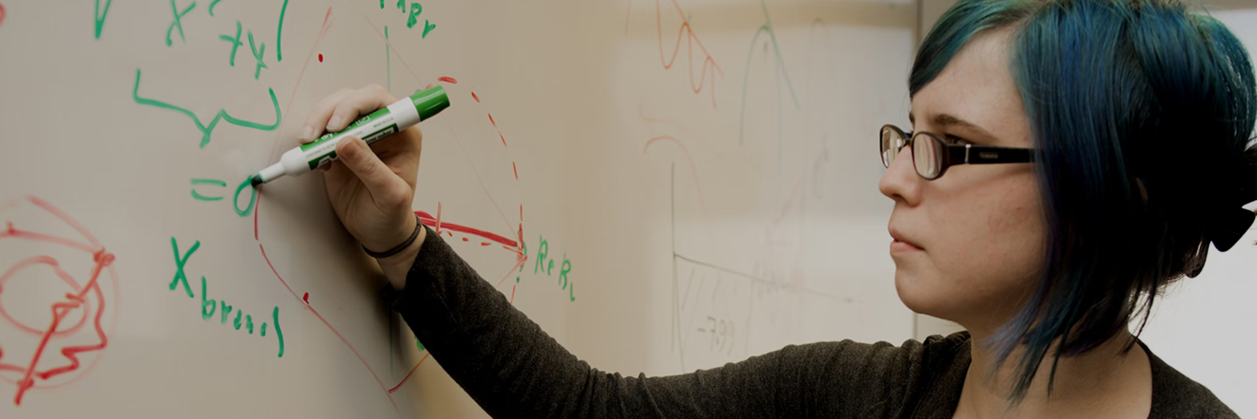 Student writing on a white board